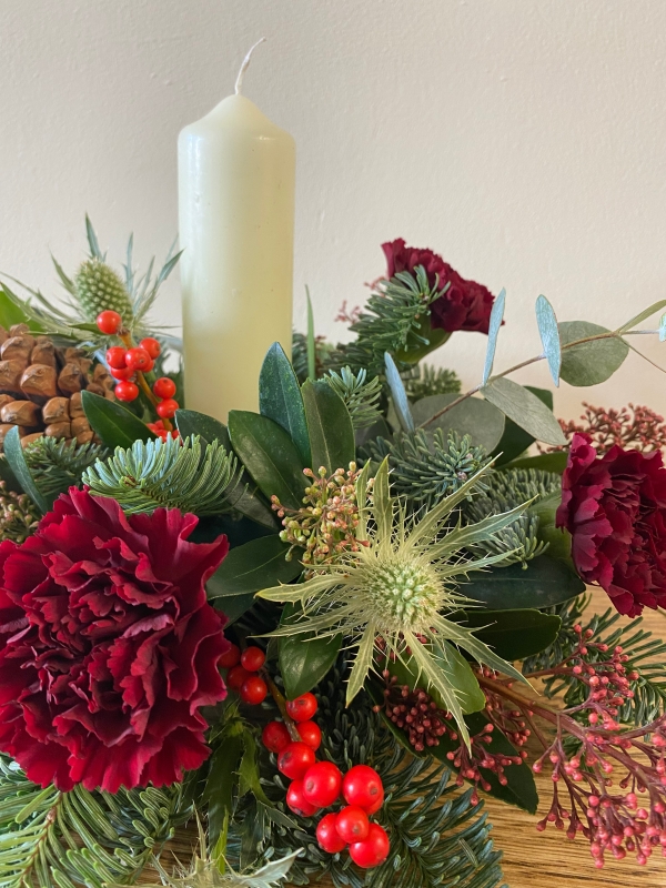 Festive round table centrepiece with candle