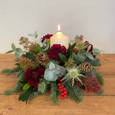 Festive round table centrepiece with candle